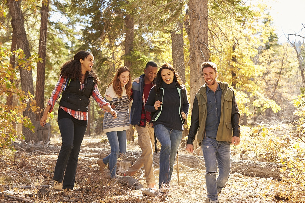 Group of friends smiling while walking together